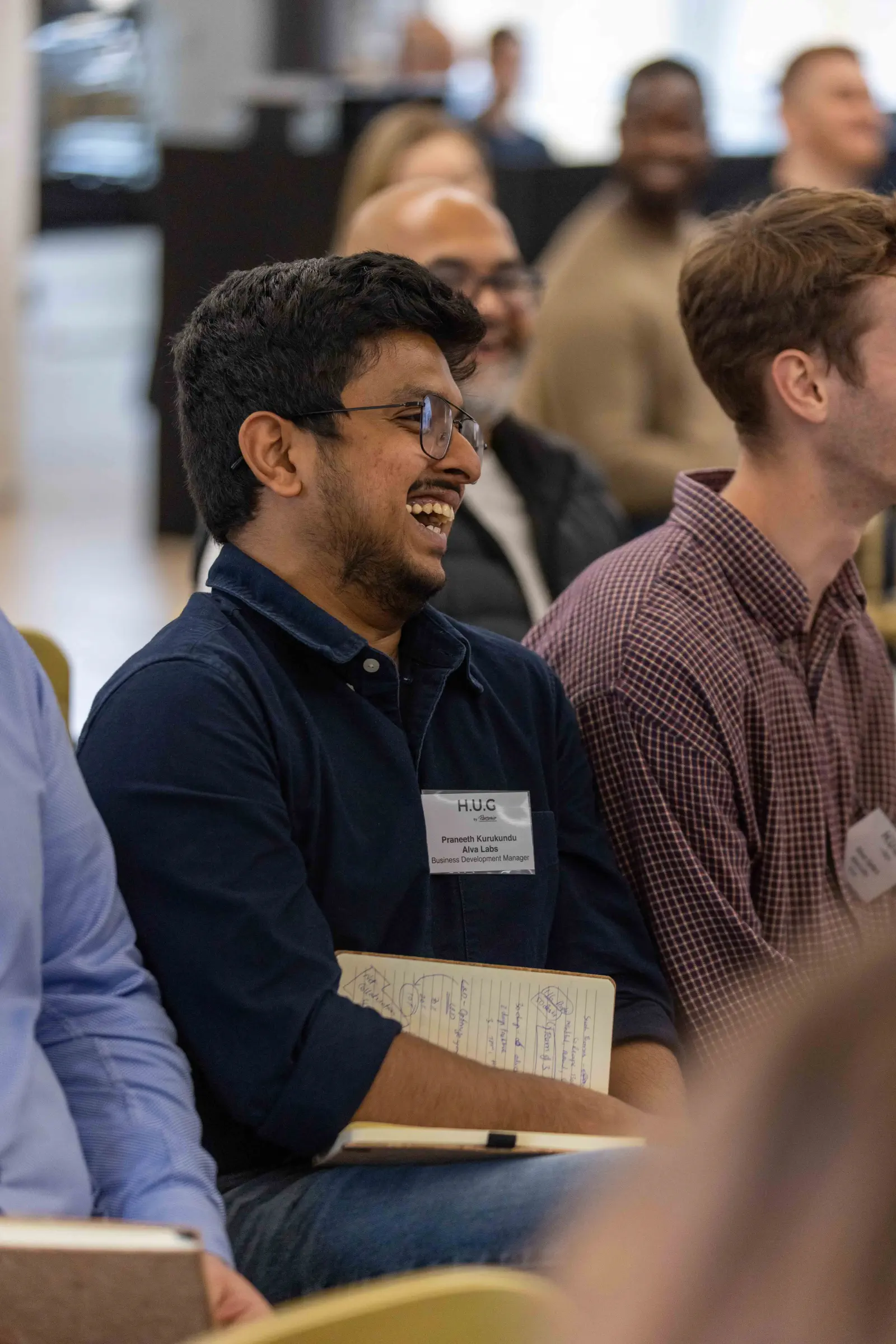 Conference attendee laughing during a session