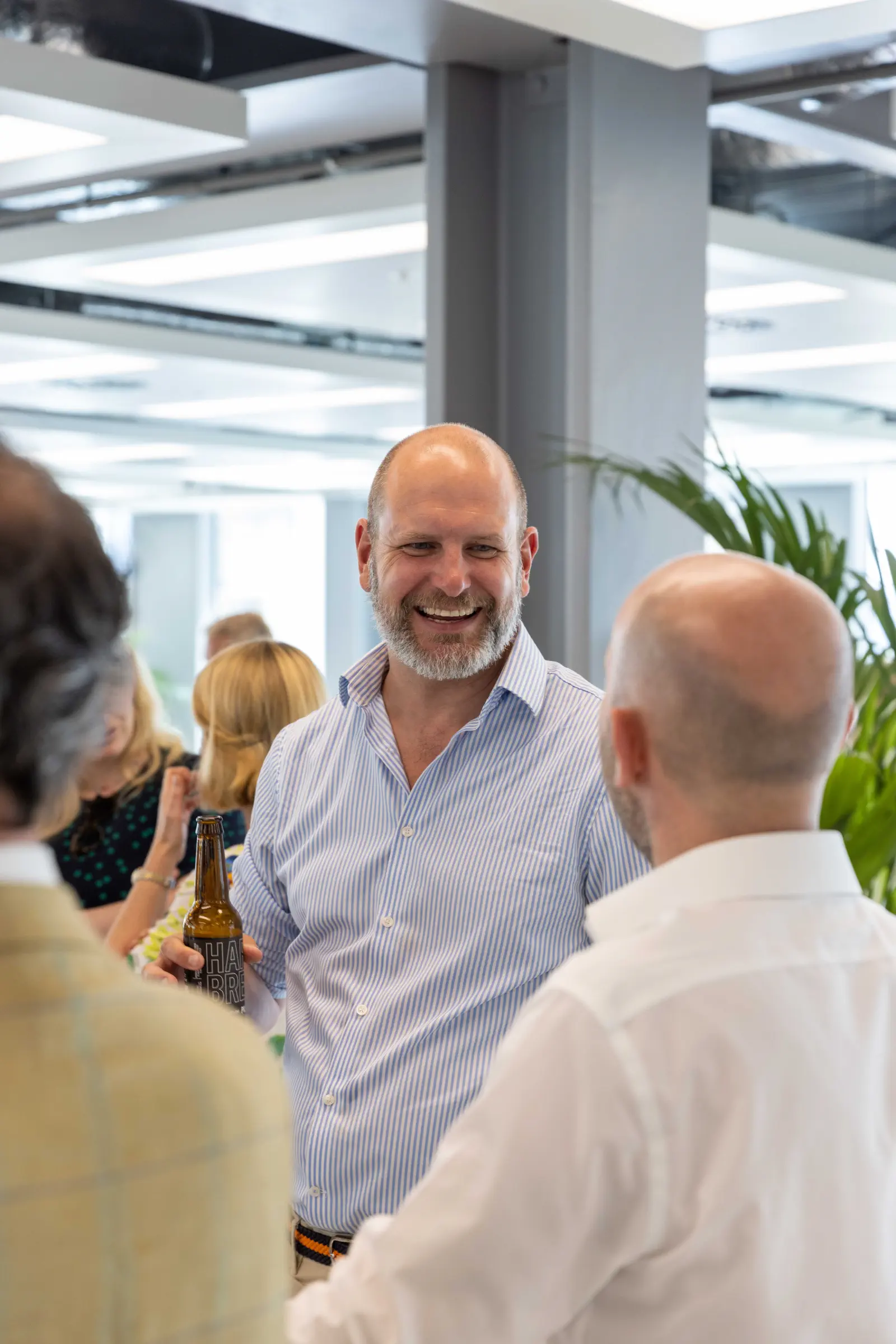 Guests laughing together at a corporate networking event